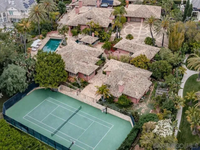 a front view of a house with a yard and palm trees