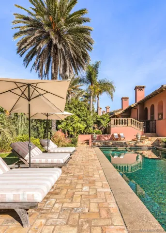 a living room with furniture a flat screen tv and a wooden floor