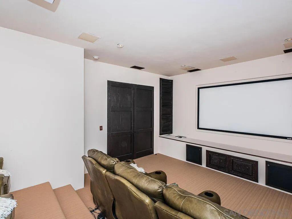 17116 Paseo Hermosa Rancho Santa Fe, CA 92067 - Photo 56 of 59 a living room with a couch and a flat screen tv