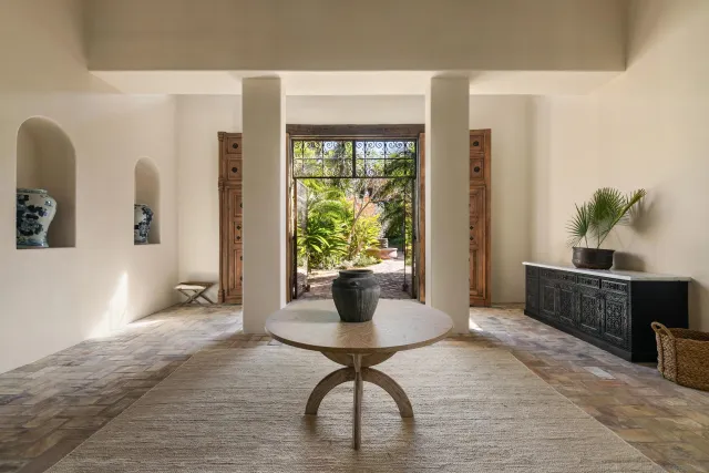 a living room with fireplace furniture and a floor to ceiling window