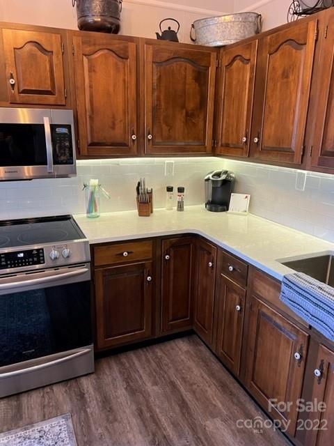 200 Golfwatch Road Canton, NC 28716 - Photo 17 of 38 a kitchen with stainless steel appliances granite countertop wooden cabinets a stove top oven a sink and dishwasher