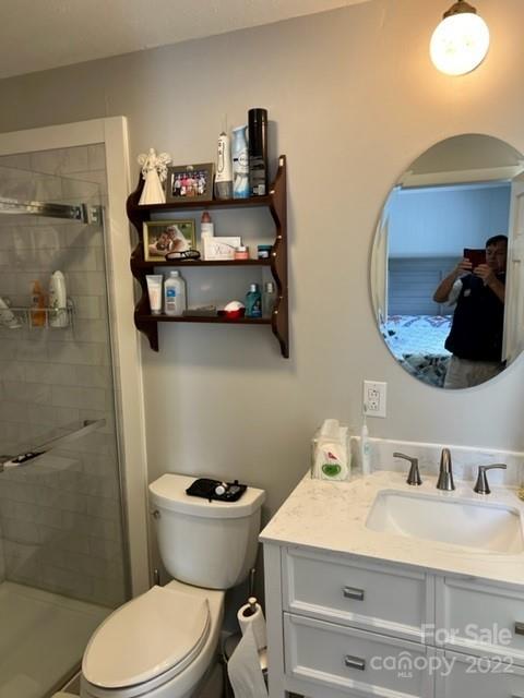 200 Golfwatch Road Canton, NC 28716 - Photo 9 of 38 a bathroom with a sink mirror and toilet