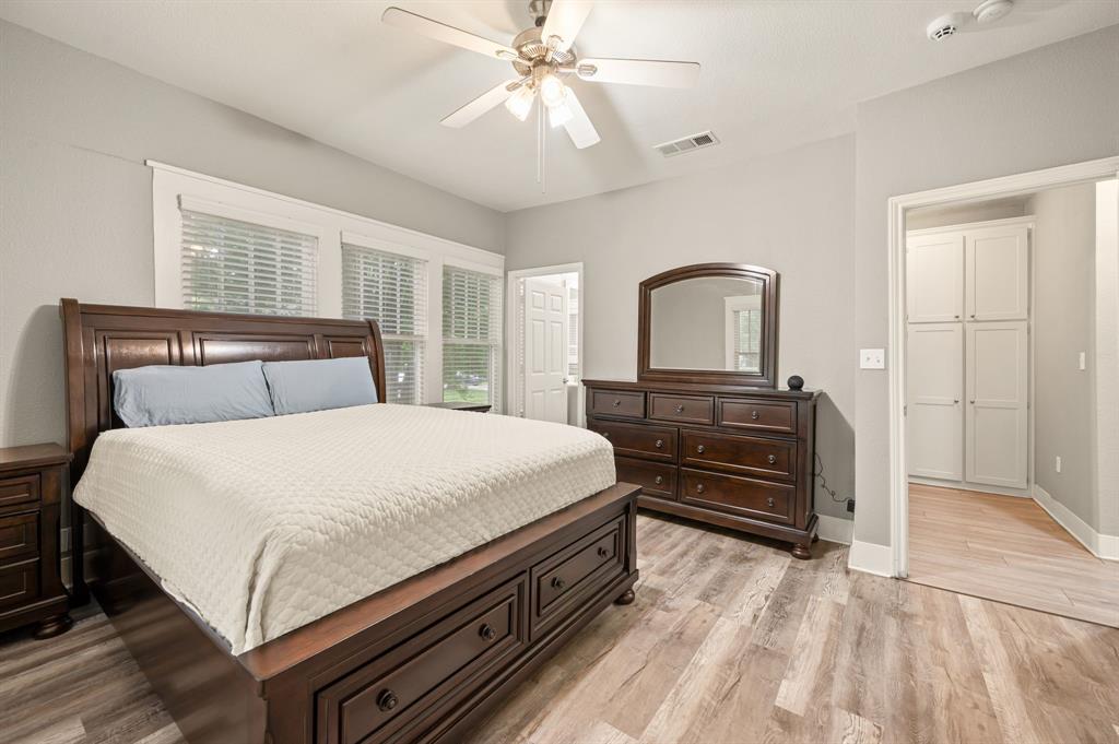 800 North Clements Street Gainesville, TX 76240 - Photo 16 of 27 a bedroom with a bed and a dresser with wooden floor
