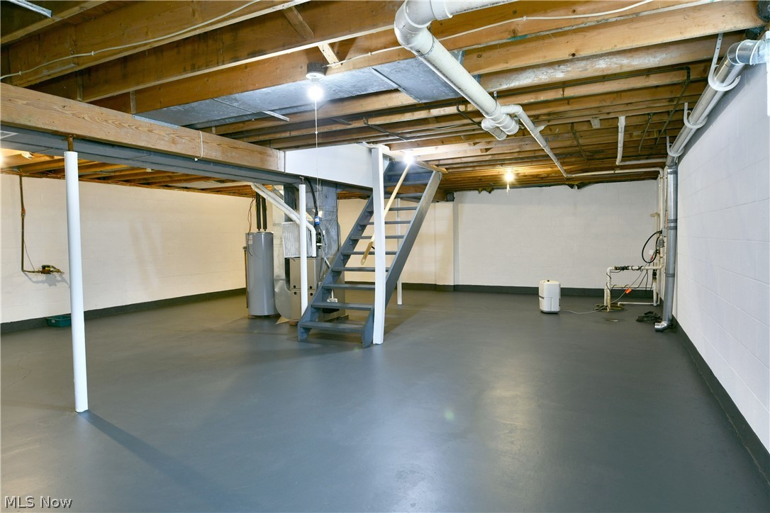 754 Warner Road Hubbard, OH 44425 - Photo 39 of 46 Expansive unfinished basement featuring painted concrete flooring and exposed ceiling joists