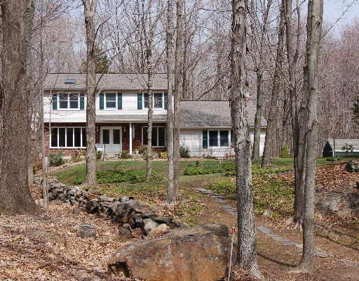 94 Obtuse Hill Road Brookfield, CT 06804 - Photo 1 of 1 a front view of a house with lots of plants and trees