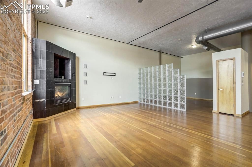 115 North Tejon Street, Unit B Colorado Springs, CO 80903 - Photo 11 of 43 a view of empty room with wooden floor and fan
