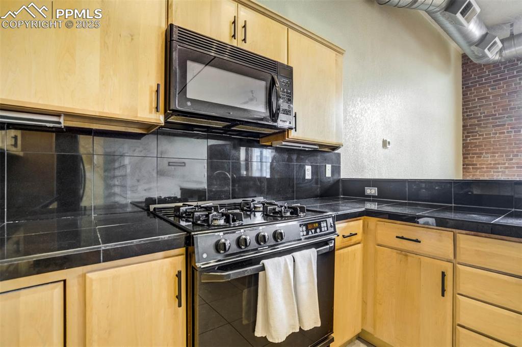 115 North Tejon Street, Unit B Colorado Springs, CO 80903 - Photo 17 of 43 a kitchen with a stove and a microwave