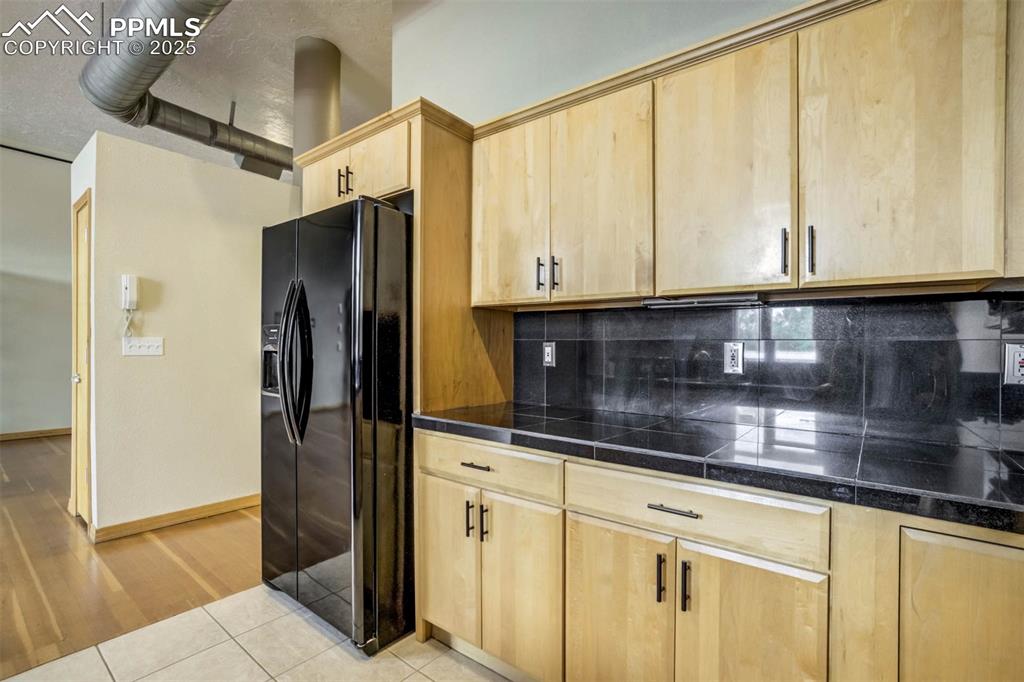 115 North Tejon Street, Unit B Colorado Springs, CO 80903 - Photo 20 of 43 a kitchen with stainless steel appliances granite countertop a refrigerator and microwave