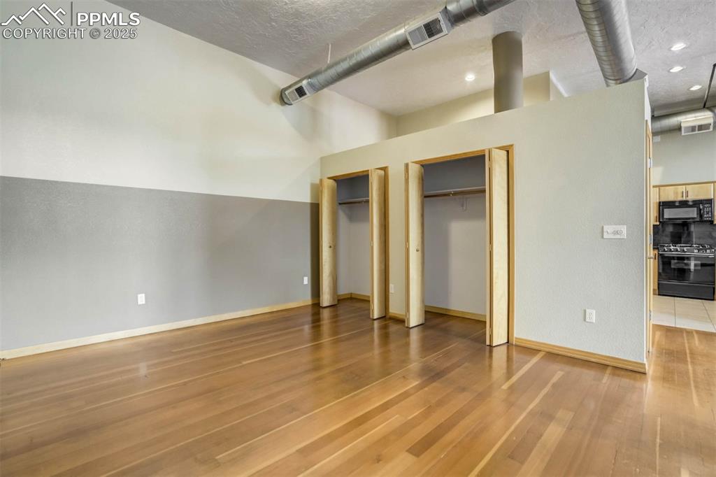 115 North Tejon Street, Unit B Colorado Springs, CO 80903 - Photo 25 of 43 an empty room with wooden floor and closet