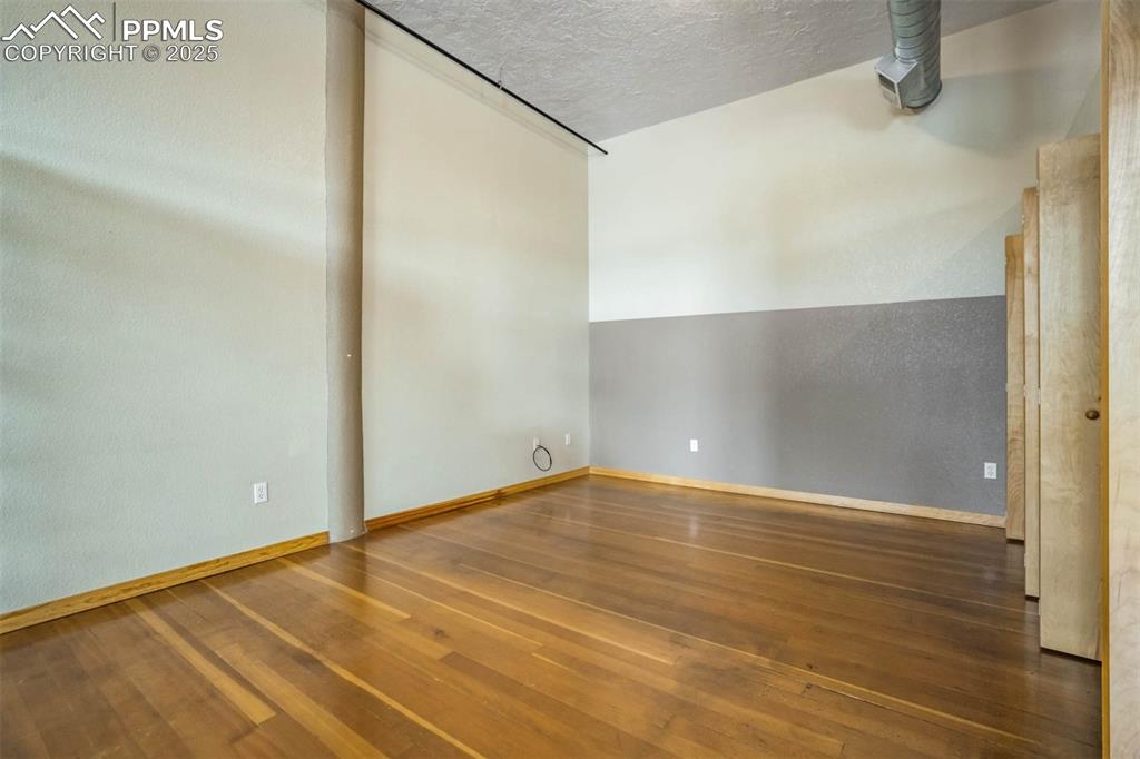 115 North Tejon Street, Unit B Colorado Springs, CO 80903 - Photo 26 of 43 a view of an empty room with wooden floor