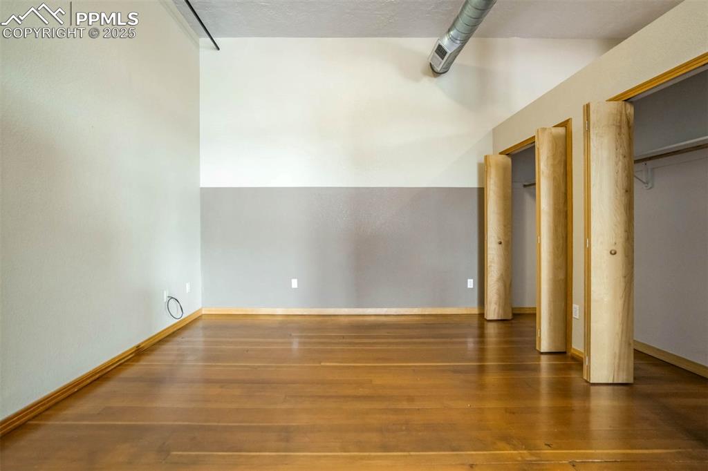 115 North Tejon Street, Unit B Colorado Springs, CO 80903 - Photo 27 of 43 a view of room with window and wooden floor