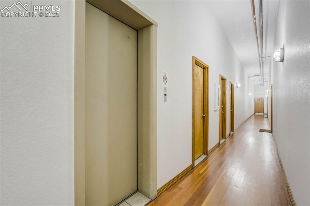 115 North Tejon Street, Unit B Colorado Springs, CO 80903 - Photo 36 of 43 a view of a hallway with wooden floor