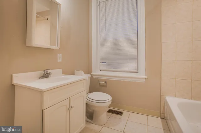 a bathroom with a sink a toilet and bathtub