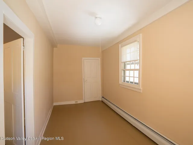 a view of an empty room and a window