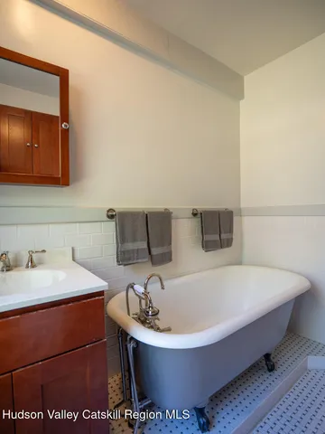 a bathroom with a bathtub and a sink