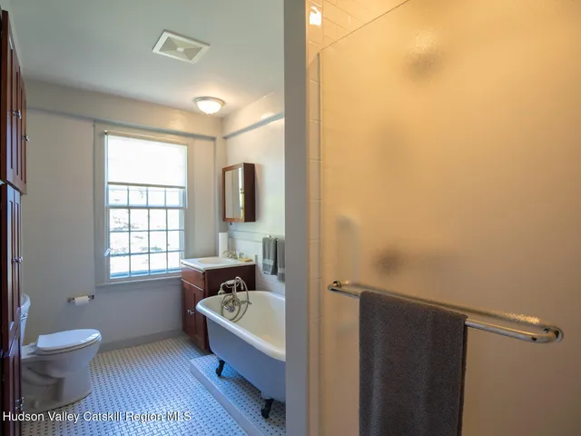 a bathroom with a bathtub and a window