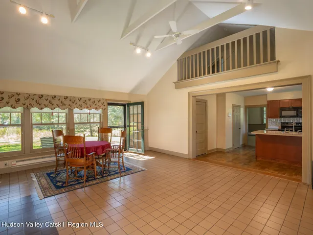a view of a livingroom with furniture wooden floor and a floor to ceiling window