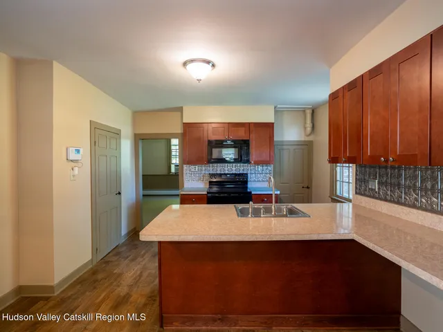 a kitchen with stainless steel appliances granite countertop a sink and a stove