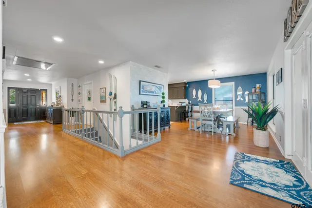 a living room with furniture fireplace and a large window