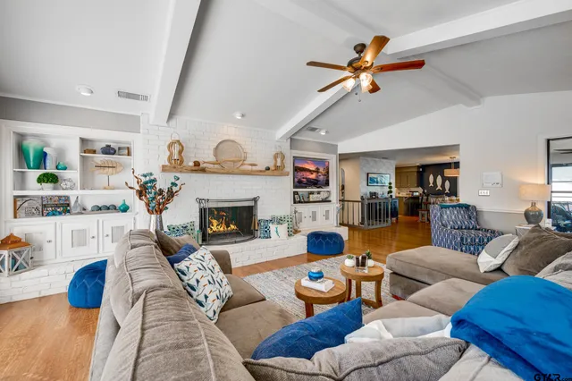a living room with furniture a flat screen tv and a fireplace
