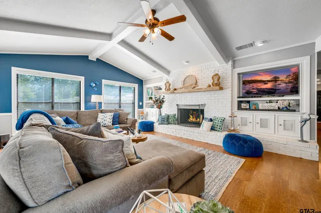 a bathroom with a granite countertop toilet sink and mirror