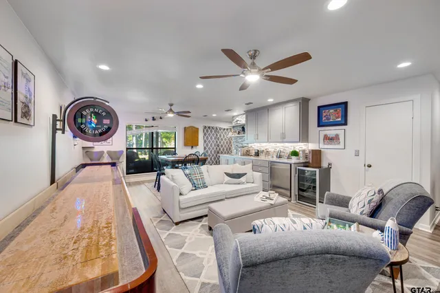 a dining room with furniture and a wooden floor