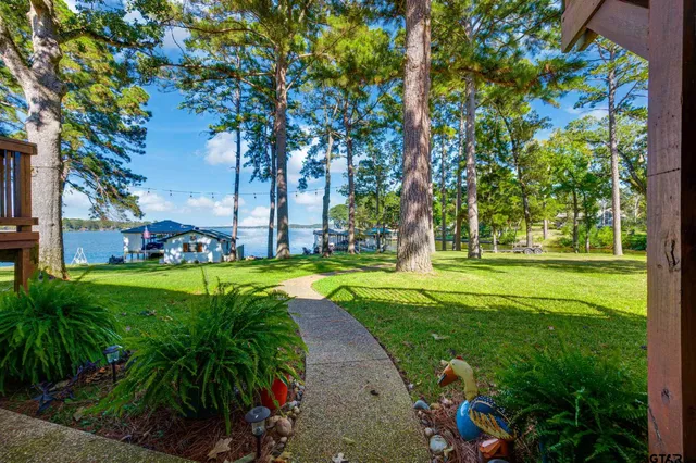 a view of a house with backyard porch and sitting area