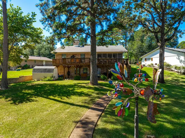 a view of a house with wooden deck