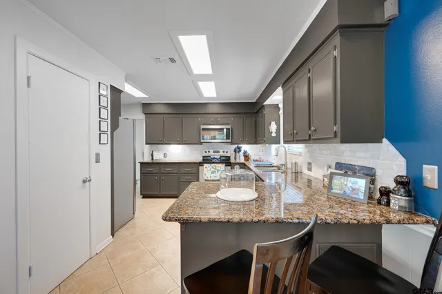 a kitchen with sink and refrigerator