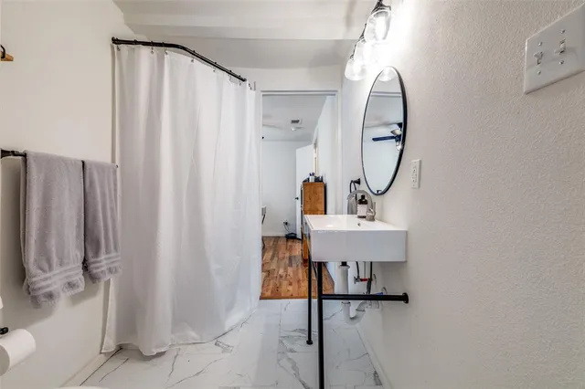 a view of a bathroom with a sink and mirror