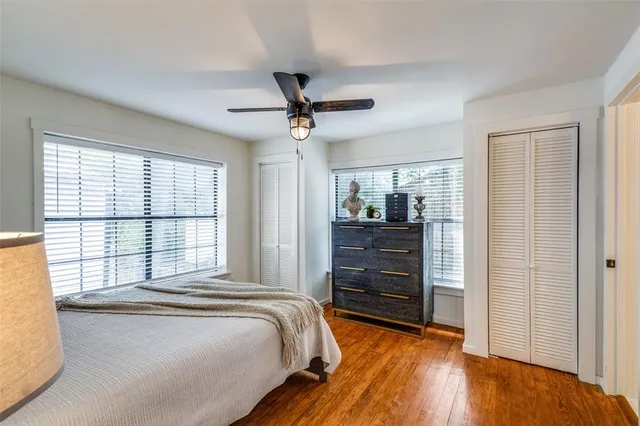 a bedroom with a bed and a dresser next to a window