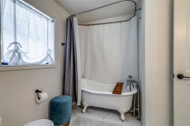 a bathroom with a tub and a sink