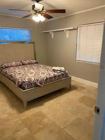 a bed sitting in a bedroom next to a window