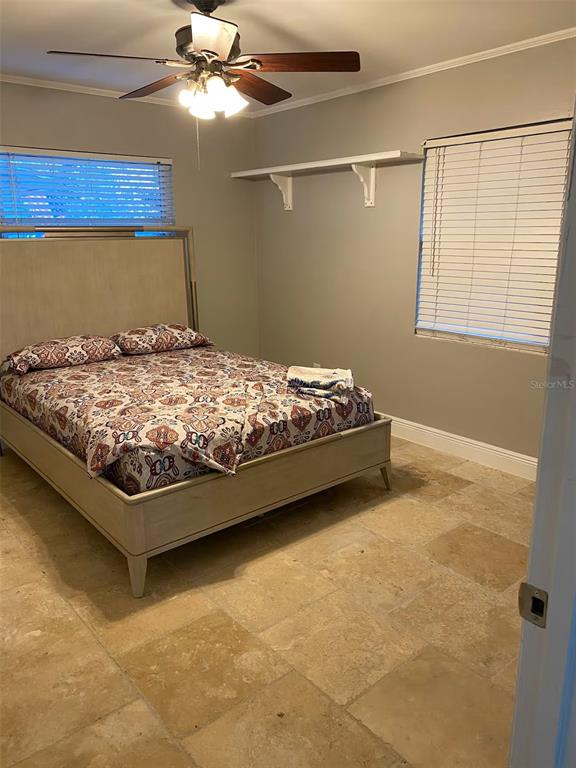 508 Ulelah Avenue Palm Harbor, FL 34683 - Photo 11 of 18 a bed sitting in a bedroom next to a window