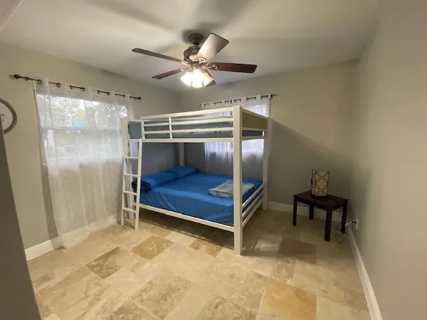 a bedroom with a bed and a chandelier