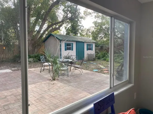 a view of a porch with chairs and backyard