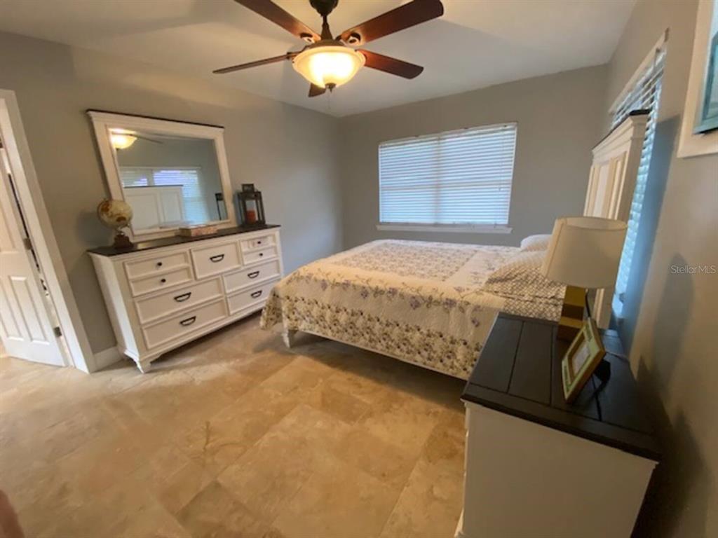 508 Ulelah Avenue Palm Harbor, FL 34683 - Photo 8 of 18 a bedroom with a bed and a flat tv screen on the dresser