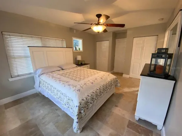 a bedroom with a bed and a chandelier
