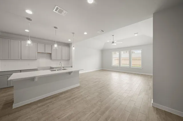 a view of kitchen with sink and wooden floor