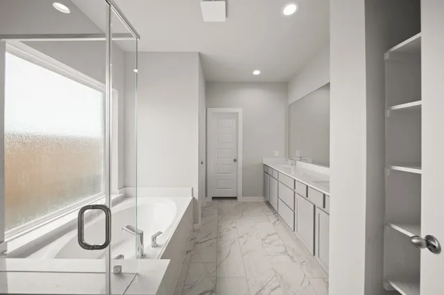 a bathroom with a bathtub and shower