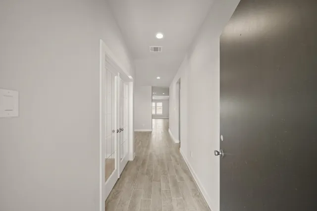 a view of a hallway with wooden floor