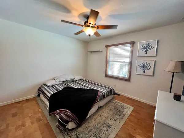 a bedroom with a bed and a chandelier