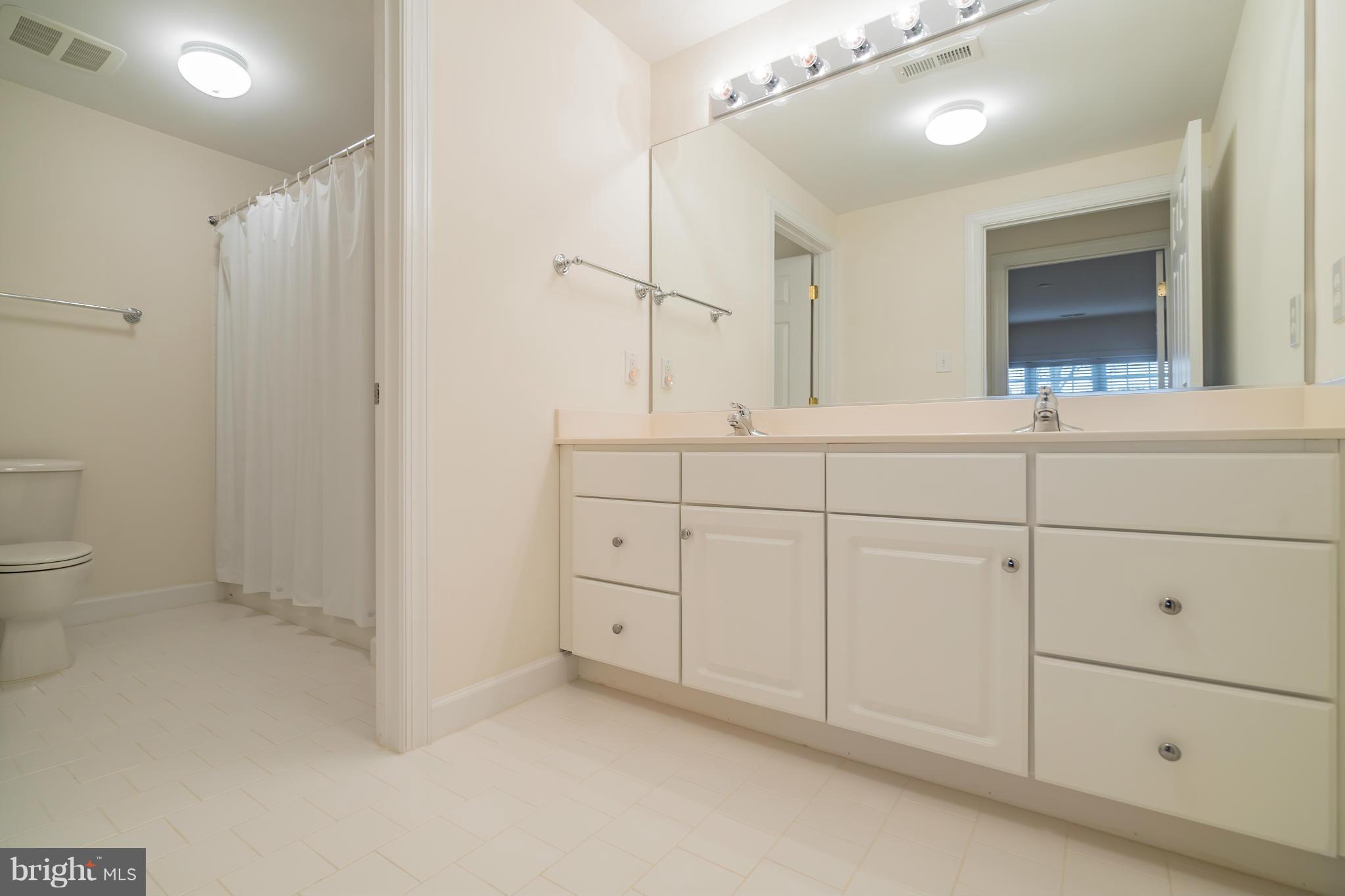 9504 Emory Grove Road Gaithersburg, MD 20877 - Photo 27 of 30 a bathroom with a sink and a mirror