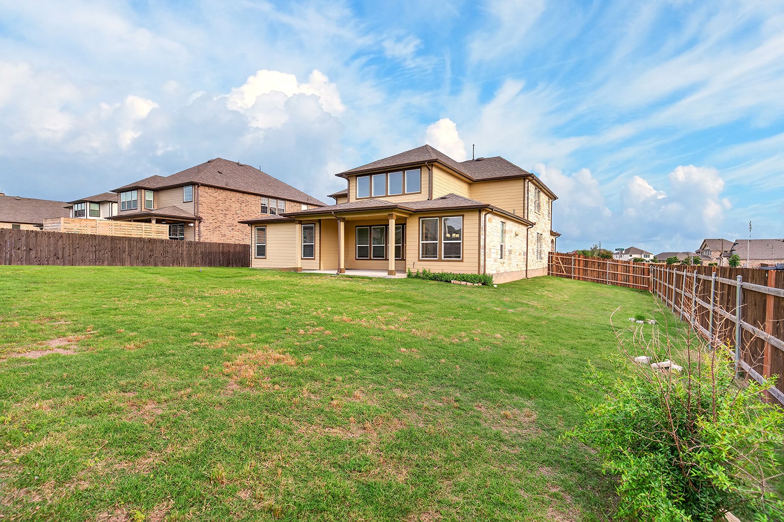 4600 Ercolano Lane Round Rock, TX 78665 - Photo 37 of 37 Expansive backyard featuring a large green lawn, full privacy fencing, and a covered patio area