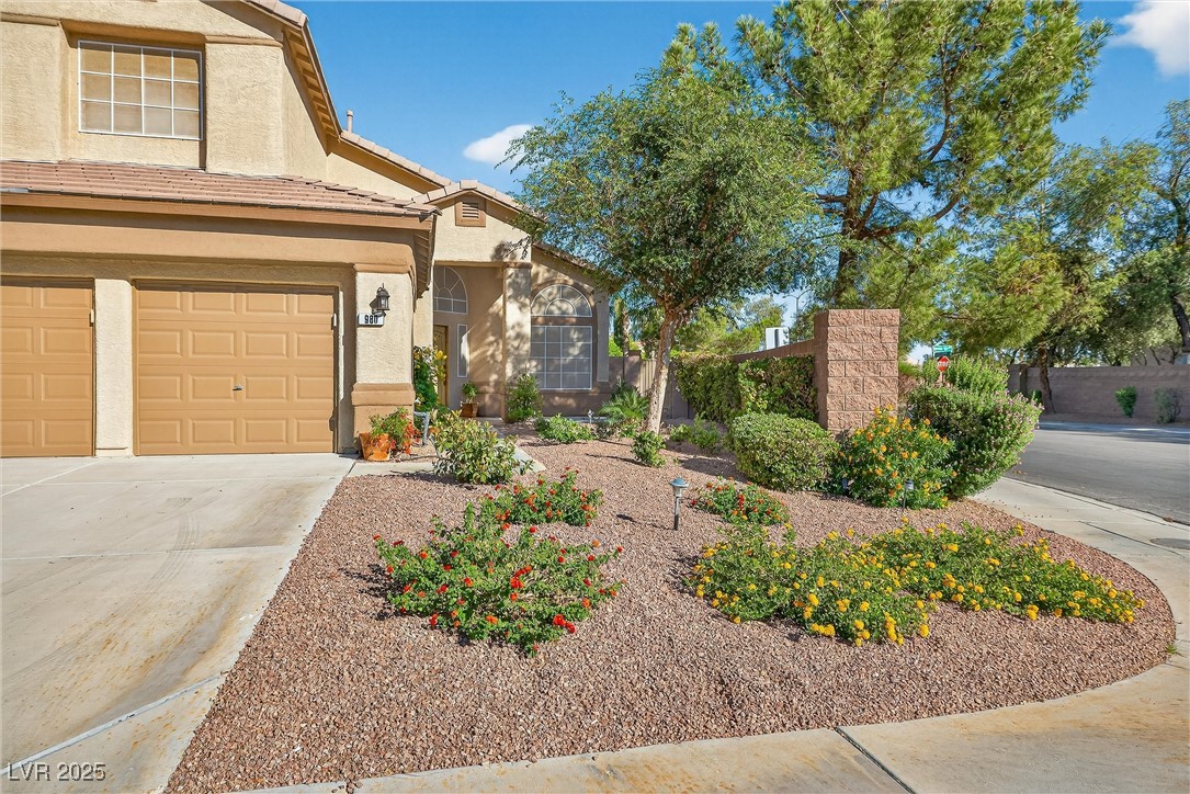 980 Upper Meadows Place Henderson, NV 89052 - Photo 11 of 58 View of front of house featuring stucco siding, driveway, a garage, and a tiled roof