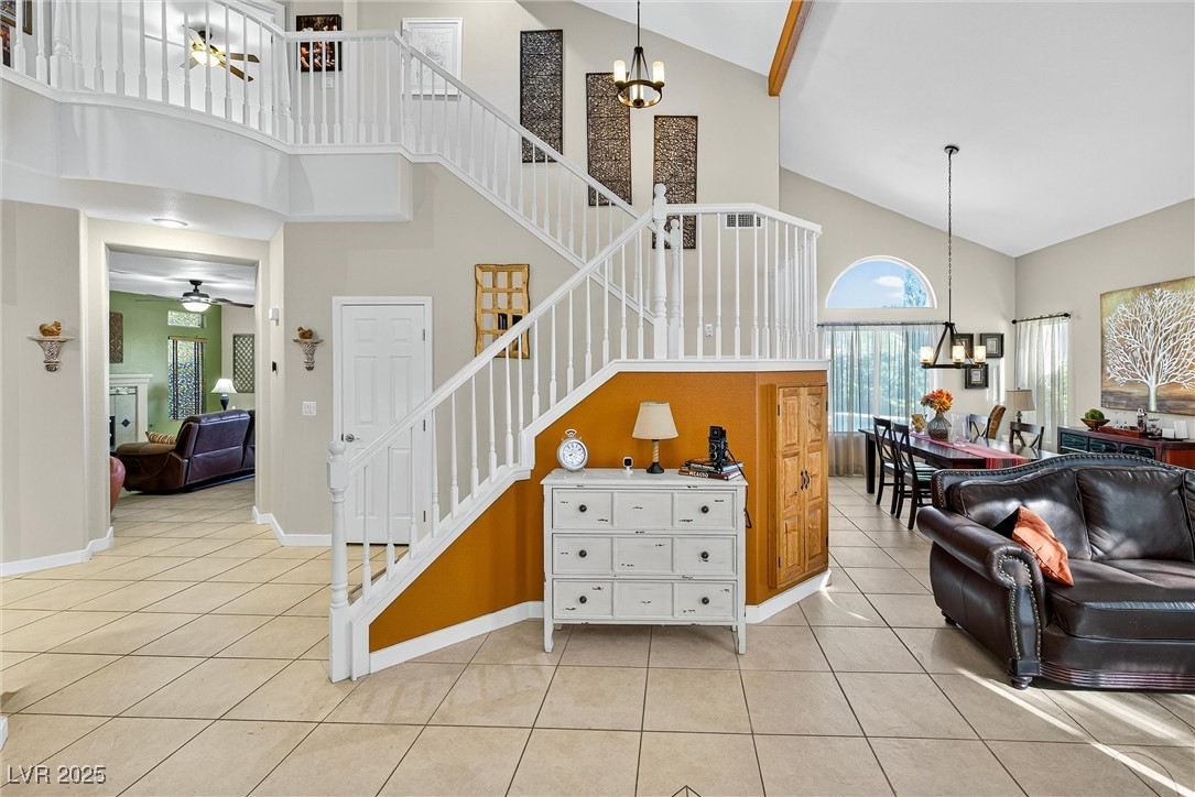 980 Upper Meadows Place Henderson, NV 89052 - Photo 14 of 58 Stairs featuring a chandelier, high vaulted ceiling, tile patterned floors, and ceiling fan