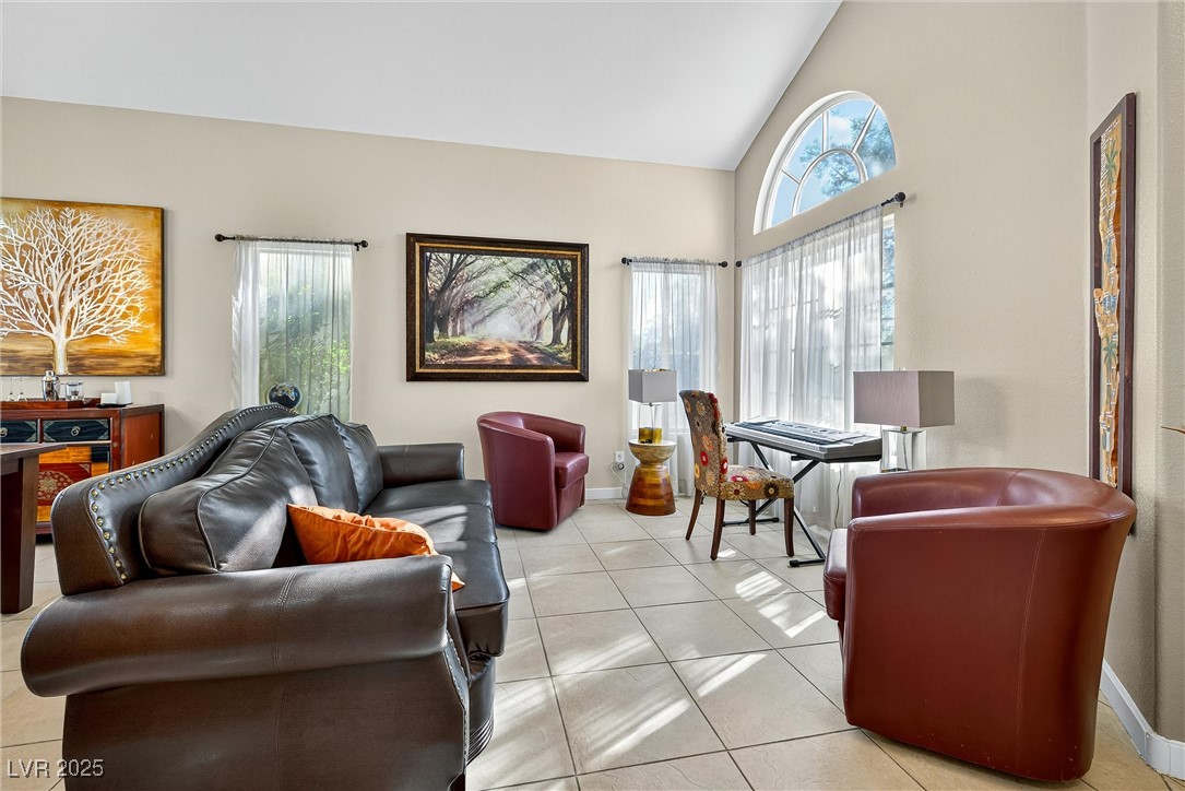 980 Upper Meadows Place Henderson, NV 89052 - Photo 15 of 58 Living area featuring light tile patterned floors and high vaulted ceiling