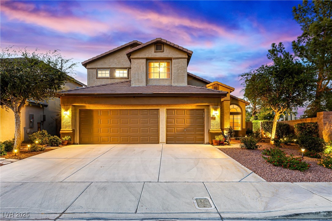 980 Upper Meadows Place Henderson, NV 89052 - Photo 2 of 58 Traditional-style house featuring concrete driveway, a tile roof, stucco siding, and a garage