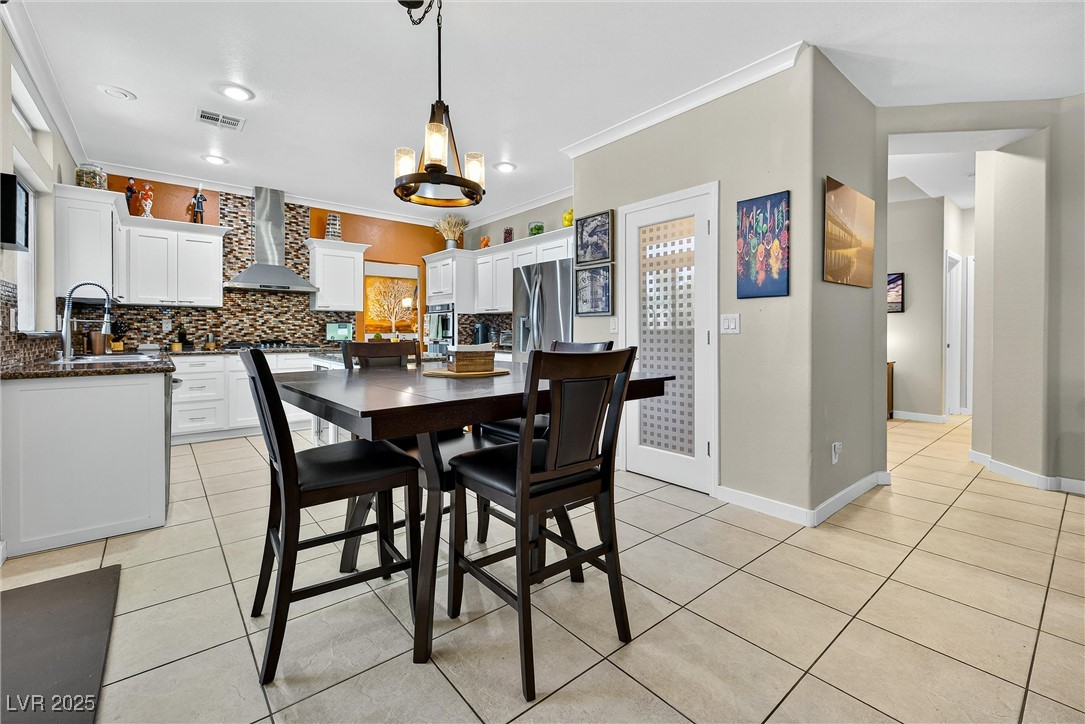 980 Upper Meadows Place Henderson, NV 89052 - Photo 22 of 58 Dining space with light tile patterned floors, ornamental molding, and recessed lighting