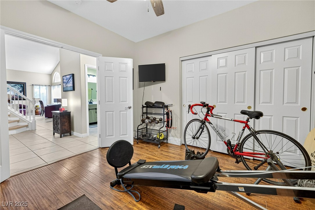 980 Upper Meadows Place Henderson, NV 89052 - Photo 27 of 58 Workout area featuring vaulted ceiling, wood finished floors, and ceiling fan